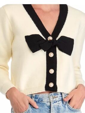Stellah Contrast Bow Cardigan, cream-colored with black bow and pearl buttons